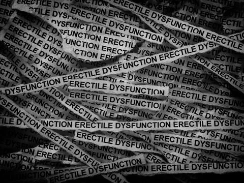 Strips of newspaper with the words Erectile Dysfunction typed on them. Stock Photos