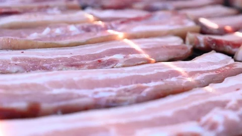 Strips of raw bacon cooking in grill bbq barbecue Stock Footage 113298580