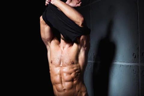 Striptease by young sexy man Stock Photos