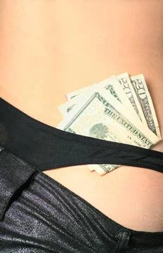 Striptiase concept striptease - dollars in the strings of the girl ,model ... Foto stock