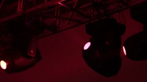 Strobe lights emitting different color beams hanging under the ceiling Stock Footage 80478188
