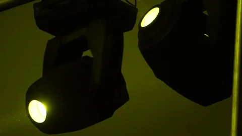Strobe lights emitting different color beams hanging under the ceiling Видео 80479033