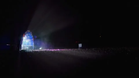 Strobe lights from the stage illuminate the crowd of fans. People jump up. Stock Footage 154158173