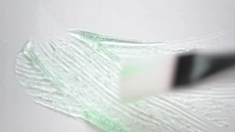 Stroking green transparent gel with brush on white surface Stock Footage 170551609