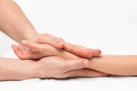 Stroking massage of hands close up on a white background Foto stock