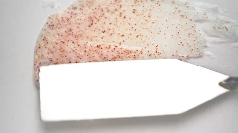 Stroking pink body scrub with shiny spatula on white surface 動画素材 170358326