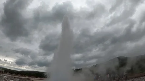 Strokkur geyser eruption with massive steam cloud and tourists, Iceland Stock Footage 334949266