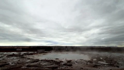 Strokkur geysir pool steaming before eruption under cloudy sky, wide angle st Stock Footage 336869691