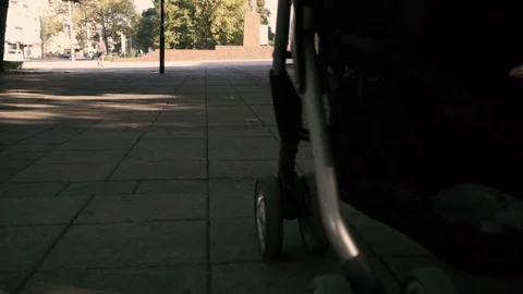 A stroller rides along the boulevard Stock Footage 91585844