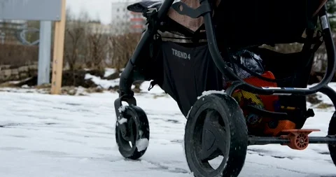A stroller rides in the snow Stock Footage 271676187