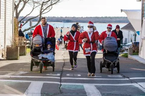 Strollers complete first uphill at start of Mattapoisett Santa 5K Run. Editor Stock Photos