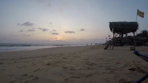 Strolling Along the Sandy Shore During a Vibrant Sunset at a Tropical Beach Stock Footage 317096449
