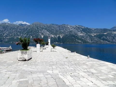 Strolling Along the Tranquil Shore of Our Lady of the Rocks Island in Kotor.. Stock Photos