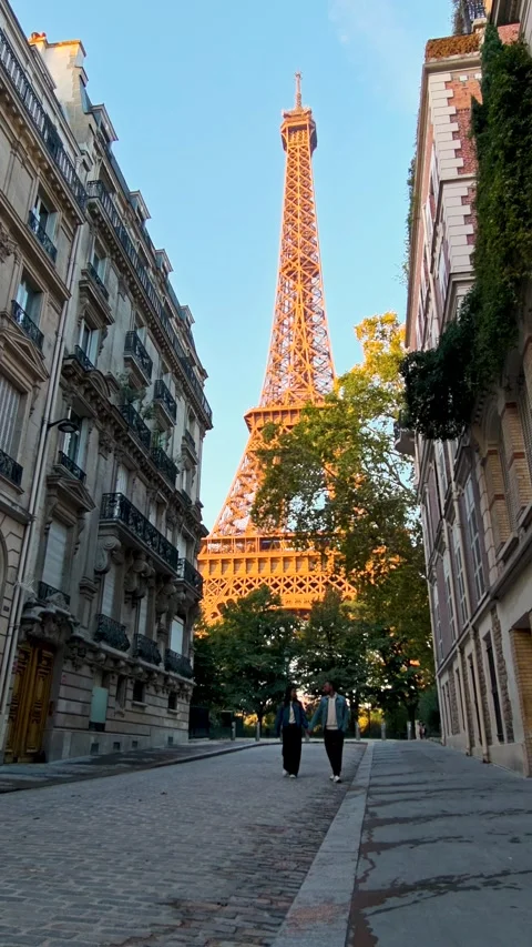 Strolling the charming streets of Paris with the Eiffel Tower aglow Stock Footage 347261326