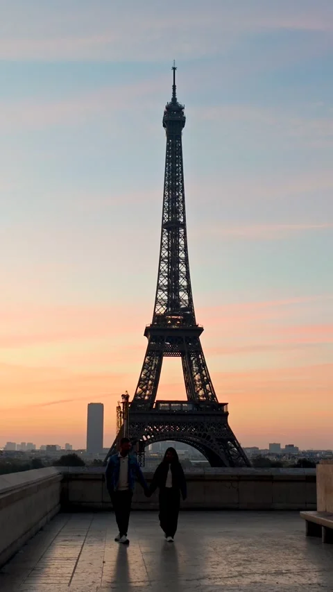Strolling hand in hand at the Eiffel Tower during sunset in Paris Stock Footage 347261009