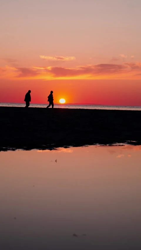 Strolling into Sunset: Two People's Journey Stock Footage 249970920