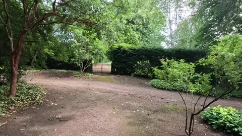 Strolling through the lush gardens of Tyninghame House Stock Footage 313127862