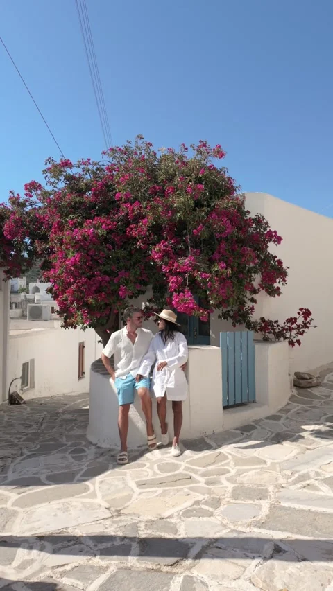 Strolling through picturesque Paros, Greece with friends amid blooming Stock Footage 336528665