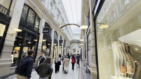 Strolling through a vibrant shopping arcade the passage Stock Footage 310527383