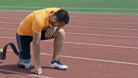 Strong Amputee Athlete Continuing Training while Suffering from Pain Stock Footage 99825909