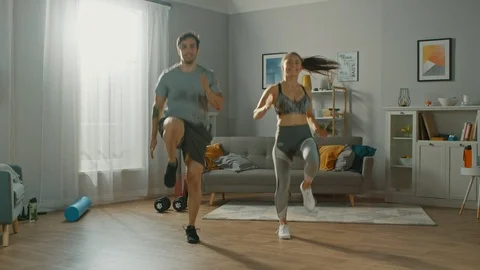 Strong and Beautiful Athletic Fitness Couple in Workout Clothes are Jogging Stock Footage