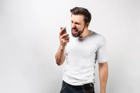 Strong and big guy is talking on the phone aloud. He is screaming words that  Foto stock