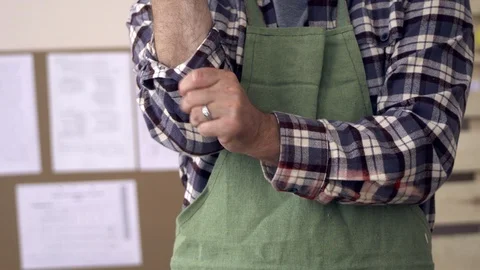 Strong and skilled hands of the carpenter is of Caucasian appearance rolling up Stock Footage 106430692