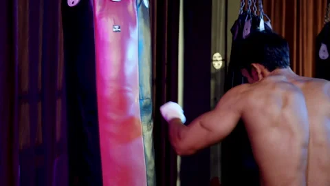 Strong Asian athletic boxer warming up to prepare for boxing in the boxing .. Stock Footage 240071946