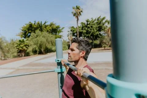 A strong athlete is doing a pull up, portrait of his face, photo with copy .. Stock Photos