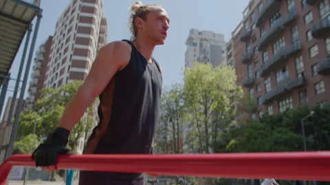 Strong Athlete Doing Tricep Dips on Parallel Bars at Outdoor Gym Stock Footage 260050284