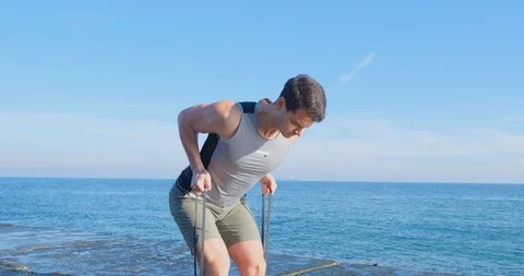 Strong athlete training on beach Stock Footage 122689876