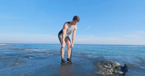Strong athlete training on beach Stock Footage 122689880