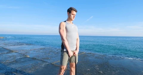 Strong athlete training on beach Stock Footage 122690243