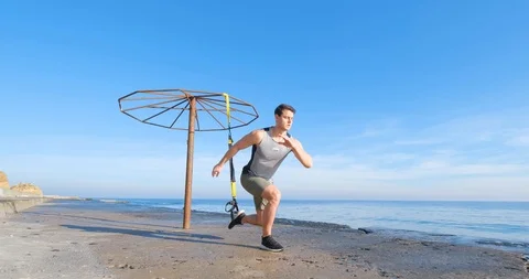 Strong athlete training on beach Stock Footage 122690245