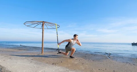 Strong athlete training on beach Stock Footage 122690272