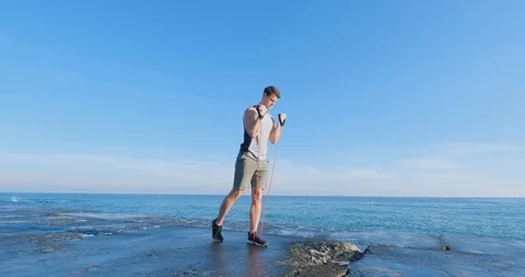 Strong athlete training on beach Stock Footage 122690544