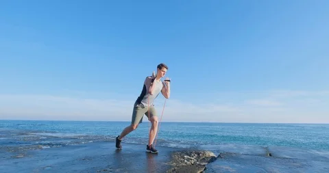Strong athlete training on beach Stock Footage 122690555