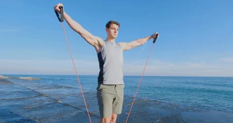 Strong athlete training on beach Stock Footage 122690605