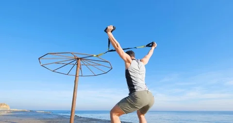 Strong athlete training on beach Stock Footage 122690636