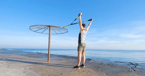 Strong athlete training on beach Stock Footage 122690762