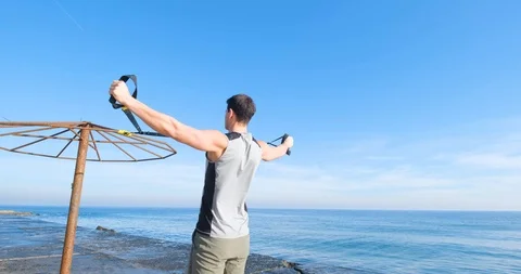 Strong athlete training on beach Stock Footage 122690768