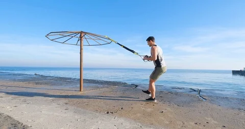 Strong athlete training on beach Stock Footage 122690792