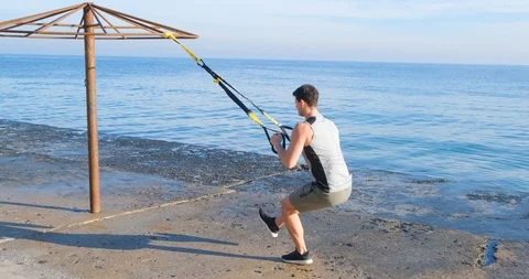 Strong athlete training on beach Stock Footage 122690800