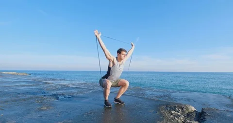 Strong athlete training on beach Stock Footage 122690828