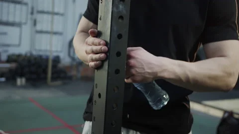 A strong athlete is trying to open his bottle of water Stock Footage 156301383