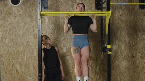 Strong athletes perform barbell exercises and focus on their workout in a gym Video stock 331019231