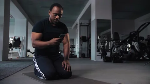 Strong Athletic Fit Black Man Using Smartphone in Between Workouts During Stock Footage 225714098