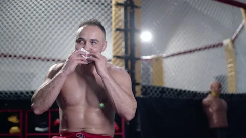 Strong athletic good looking man eat healthy food at gym and pumping up muscles Stock Footage 155650602