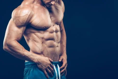 Strong athletic man on black background Stock Photos