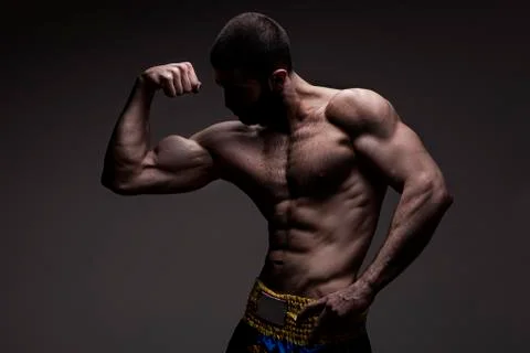 Strong athletic man on black background Stock Photos